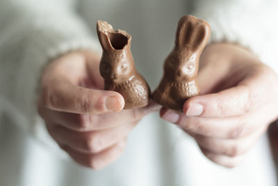 Close-up of woman hands holding chocolate easter bunny