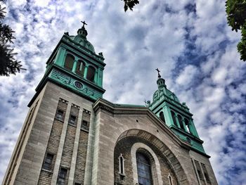 Low angle view of building against cloudy sky