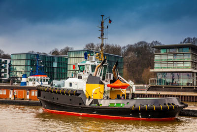 Tugboats docked at the hamburg port on the banks of the elbe river