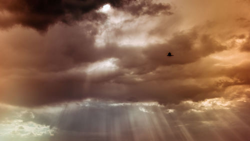 Low angle view of storm clouds in sky during sunset