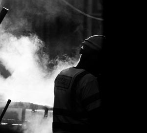 Portrait of man smoking on car