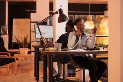 Businesswoman talking on landline phone