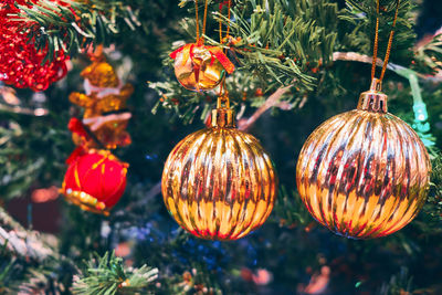 Golden colored spheres at new year tree. new year decorations. christmas tree.