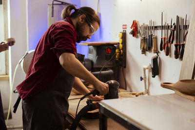 Side view of man working in factory