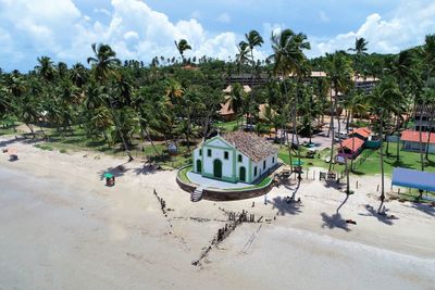 Panoramic view of people on beach against sky