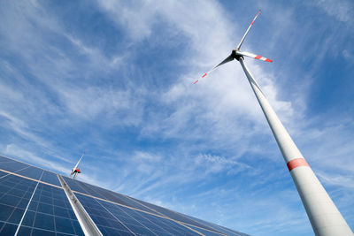 Low angle view of windmill against blue sky