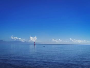 Scenic view of sea against blue sky