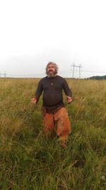 Portrait of man on field against sky