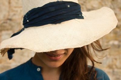 Close-up of young woman wearing hat