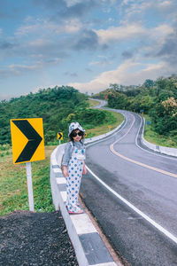 Full length of man standing on road against sky