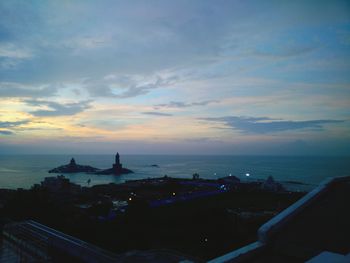 Boats in sea at sunset