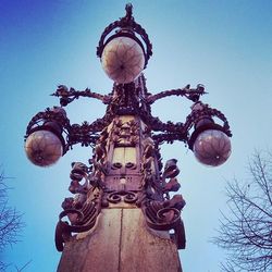 Low angle view of illuminated light against blue sky