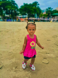 Portrait of cute baby girl on beach