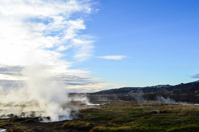 Scenic view of waterfall against sky