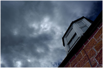 Low angle view of building against cloudy sky