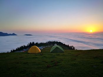 Scenic view of campground against sky during sunrise