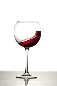 Close-up of wineglass against white background