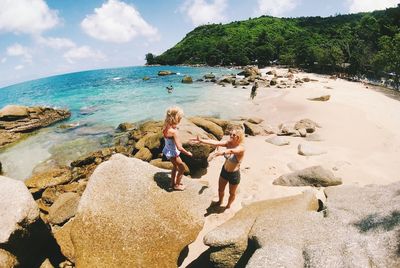 People on beach against sky