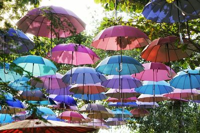 Multi colored umbrellas against sky