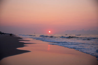 People walking at sunrise on topsail island