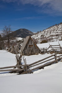 Scenic view of snow covered field against sky