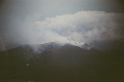 Scenic view of mountains against cloudy sky