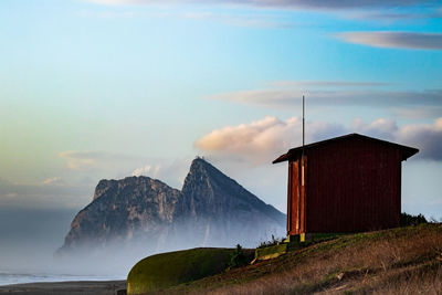 Building by sea against sky