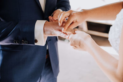 Midsection of couple holding hands