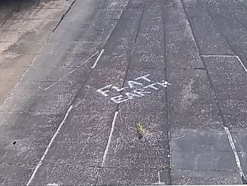 High angle view of arrow sign on road