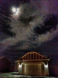 Low angle view of illuminated building against sky