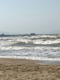 Scenic view of beach against clear sky