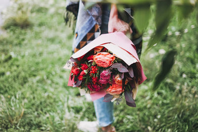 Happy young woman with bouquet 