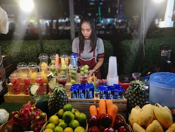 Woman looking at market stall at night