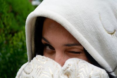 Close-up portrait of woman wearing covering face