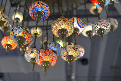 Low angle view of illuminated lanterns hanging at market stall