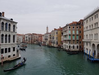 Boats in canal along buildings