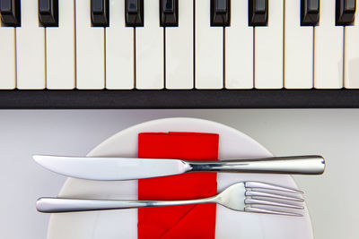 High angle view of piano keys on white table