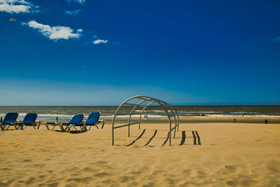 Scenic view of beach against blue sky