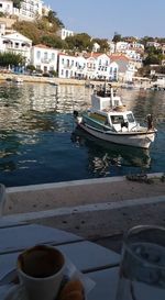 Boats in river in front of buildings