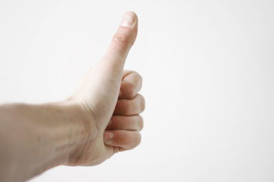 Close-up of hand over white background