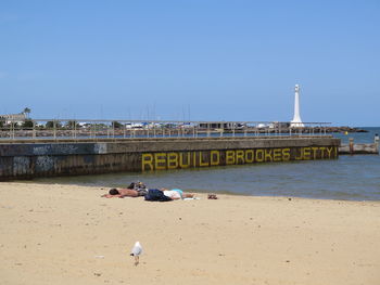 Built structure on beach against clear sky