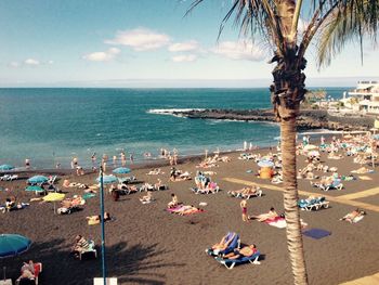 People on beach against sky