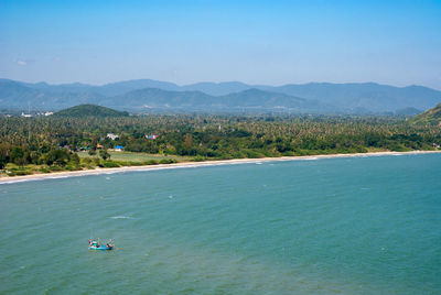 High angle view of sea and mountains against sky