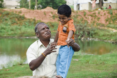 Father and son standing in lake