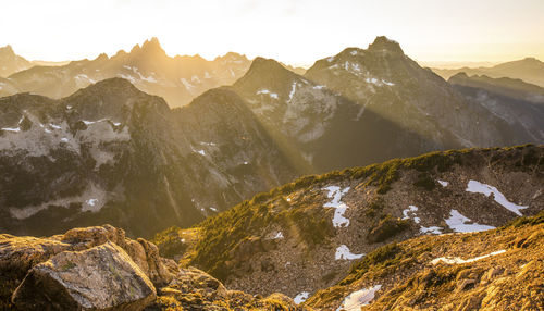 Tranquil scene of mountain range filled with rays of sunlight.