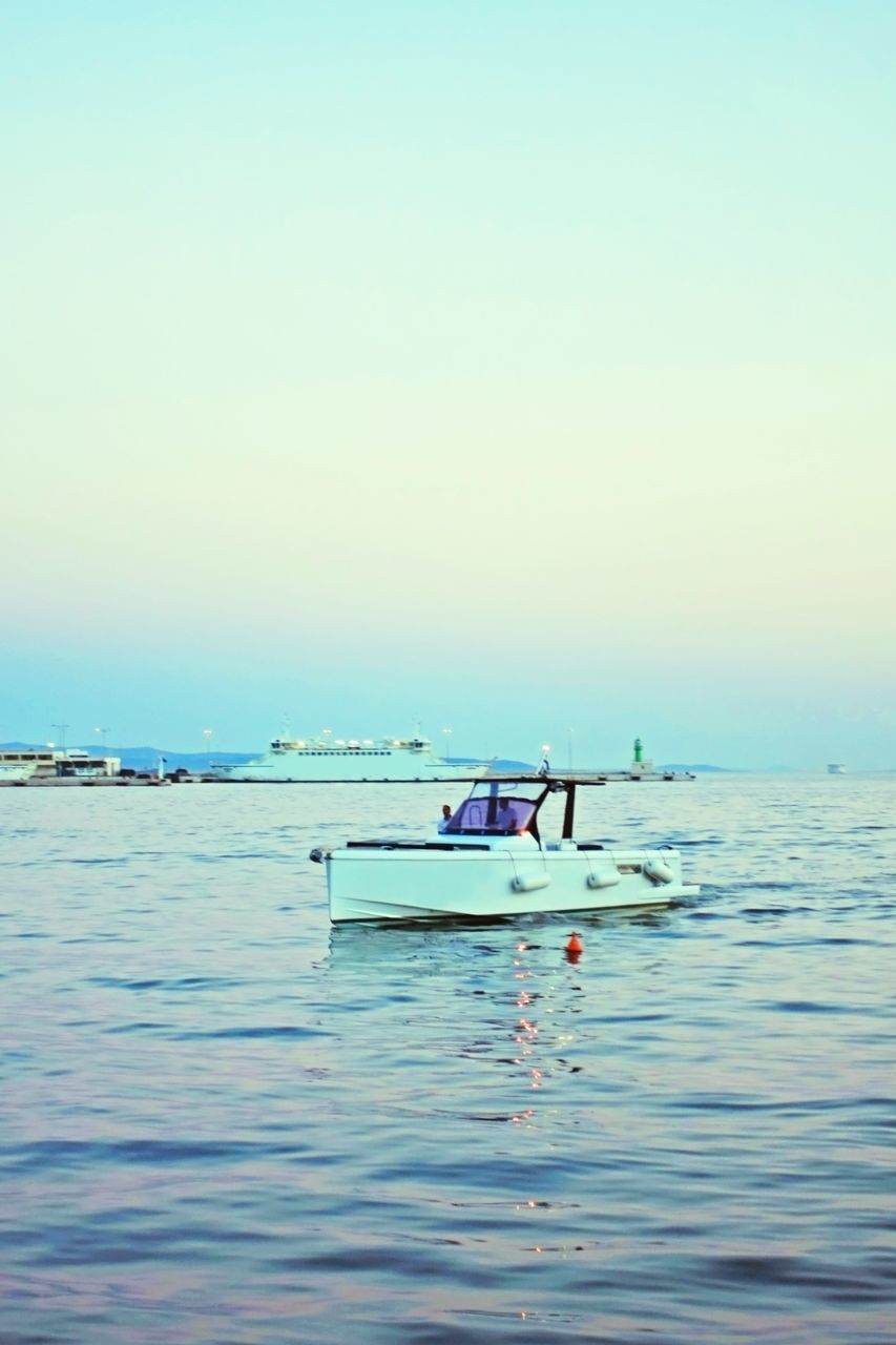 BOAT IN SEA AGAINST CLEAR SKY