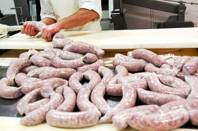 Midsection of man preparing food in commercial kitchen