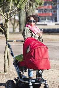 Woman with cell phone and pram