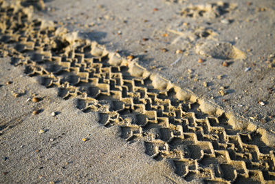 High angle view of tire track on shore at beach