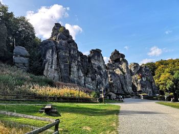 View of rocks on field against sky